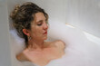 © Martin - Attractive young woman relaxing in bathtub