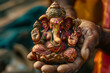a local resident holds the Indian god Ganesh in his hand

