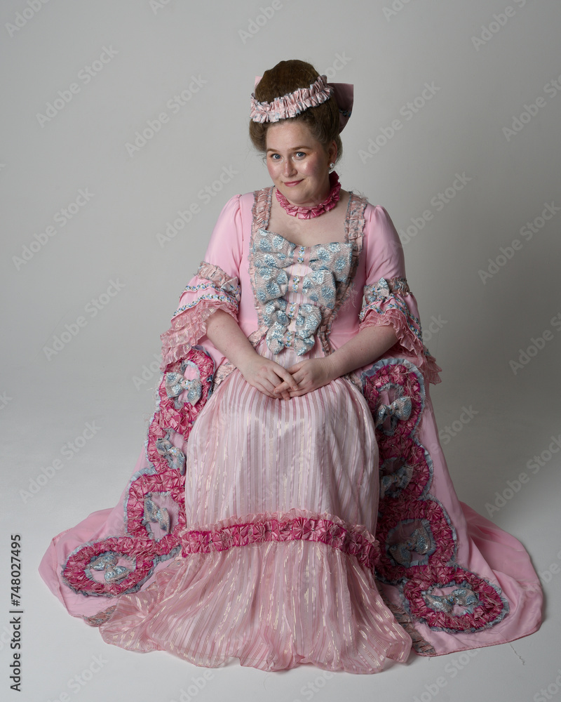 Nobility Style Fun length portrait of female model wearing an opulent pink gown ...