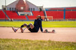 © Hip.hub - Asian para-athlete relaxes and Warm-up runner prosthetic leg on the track alone outside on a stadium track Paralympic running concept.