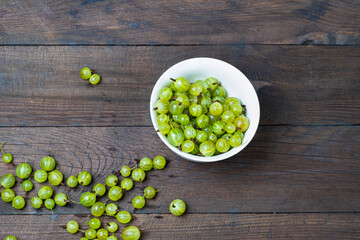 Sticker - Ripe green gooseberries on a wooden table. Organic gooseberries.