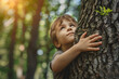 Net zero and carbon neutral concept. Child hugging a tree in the outdoor forest. global problem of carbon dioxide and global warming. Love of nature. greenhouse gas emissions target Climate neutral 