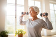 An elderly woman lifts dumbbells, a concept of health care in old age