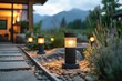 Modern solar-powered lights cast a warm glow along a stone garden path, enhancing the ambiance near a house as the evening approaches.