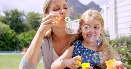 Poster - Woman, young girl in garden with bubbles and fun together outdoor, parent and child with game and toys. Liquid soap, happy mother and daughter in backyard at home, playful and smile with bonding