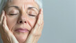 © MFlex - Portrait of beautiful mature woman with closed eyes touching her face, copy space