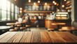 Wooden table frontal view with blurred coffe shop background