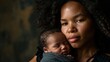 Beautiful black mother embracing newborn baby, expressing love, warmth, and the bond between mother and child on a dark background