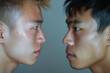 Side view of Asian men's faces facing each other. Confrontation between two people, conflict