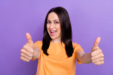 Sticker - Photo of impressed overjoyed woman with straight hair dressed orange t-shirt showing thumb up to you isolated on purple color background