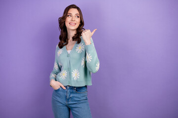 Wall Mural - Photo of attractive model female in stylish clothes pointing finger showing promo offer mockup isolated on violet color background