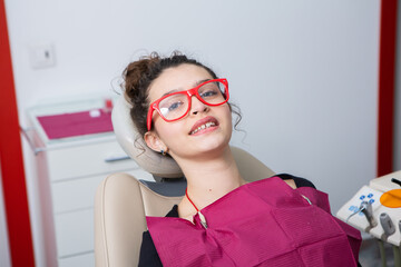 Stomatology and tooth care. Dentistry and oral health. Woman have teeth examination at dentistry clinic. Closeup young caucasian girl face.