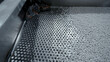 Cleaning of polymer granules. Creative. Mesh for cleaning white polymer granules from debris and foreign particles. Chemical workshop for plastic processing and cleaning