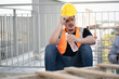 Portrait very tired worker Caucasian man with holding bottle and drink water at construction site	