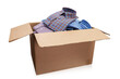 Open cardboard box full of men's folded shirts isolated on white background