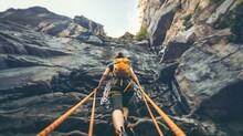 A brave hiker gazes up at a towering mountain with a rope and climbing gear in hand. With each step they conquer the steep incline and conquer fears showcasing the ultimate