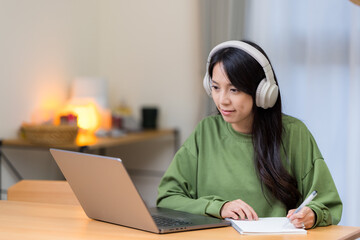 Poster - Woman study on laptop computer with her headphone