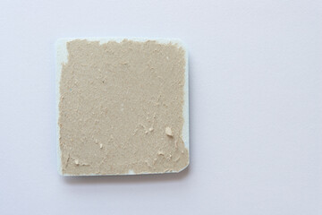 torn cardboard patch with 3d element on textured paper