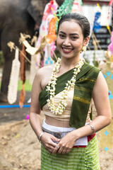 Smiling Thai woman in traditional Thai clothing and jasmine garland at Song kran festival in Chiangmai Thailand