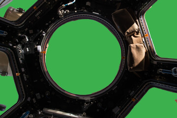 Wall Mural - porthole of space station isolated on green background. elements of this image furnished by nasa.