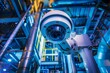 A high tech security camera is installed in an industrial setting showcasing the futuristic style of industrial automation and safety measures in a factory with CCTV in ducts and robotics