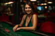 Woman playing in casino. Woman stakes piles of chips playing rou