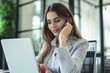 © PhotoPhantom - Young executive managing business communications via smartphone, in office environment.