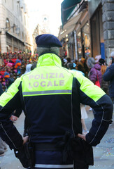 Wall Mural - Italian city with policeman on guard with text on uniform meaning Local Police