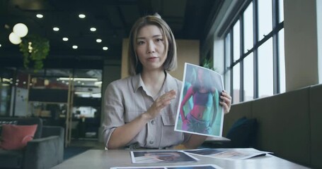 Canvas Print - Animation of graph processing data over asian female creative having video call at casual office