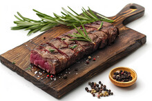 Juicy beef with salt, seasonings and rosemary on a rustic wooden board on a white background