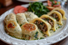 A plate of Maultaschen, a traditional Swabian dish consisting of an outer layer of pasta dough filled with minced meat, smoked meat, spinach, bread crumbs and onions