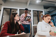 © qunica.com - Multicultural business team reviewing financial statements and discussing market analysis.