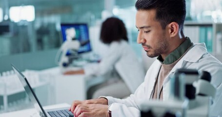 Laptop, typing or scientist with microscope or research in lab for a chemistry report or medical test feedback. Bacteria, Asian man science update for online medicine development news on website