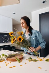 Wall Mural - Healthy, Beautiful Caucasian Woman Standing in the Kitchen, Holding a Fresh Salad: A Portrait of a Young, Attractive Lady Engaged in Cooking a Healthy and Natural Vegetarian Meal.