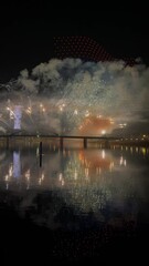 Wall Mural - Footage of colorful fireworks on the black sky background over-water.4K.