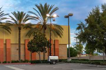 Portable mobile trailer with floodlight in a parking lot