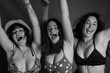 Monochrome Image of Three Joyful Women Celebrating Friendship with Elation