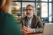 © Stock Globe - Middle aged mature older business man hr manager, lawyer, bank adviser having work conversation at office meeting or job interview. Financial legal advisory and consultancy services, Generative AI