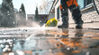 Man Pressure Washing Sidewalk of a House on a Beautiful Day