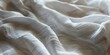Abstract White pillowy fabric weave of cotton or linen satin fabric lies texture background.