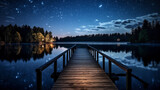 Fototapeta  - A starry night sky reflecting on a calm lake, with a dock leading into the water. 