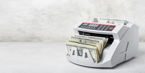 Sticker - Modern cash counting machine with dollar banknotes on light background