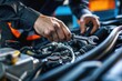 © ttonaorh - Close-up of a mechanic's hands repairing a car engine, depicting expertise in vehicle maintenance