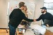 © Jacob Lund - Successful partnership: Business men shaking hands in a creative tech company