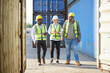 © offsuperphoto - group of workers walking and talking about work or project in containers warehouse storage