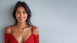 © pariketan - Indian woman in red halter V-Neck smiling isolated on grey