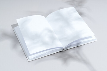 Canvas Print - Blank open notepad on gray background studio shot