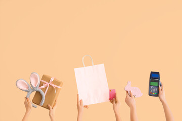 Poster - Women with payment terminal, credit card, bag and Easter decor on beige background. Online shopping