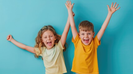 Two happy kids in yellow T-shirts on a blue background. Happy siblings day