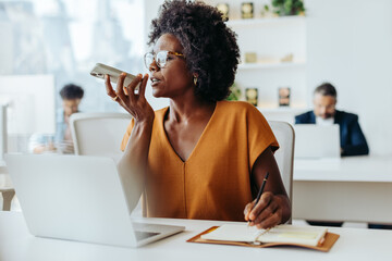 Successful female entrepreneur working on laptop in modern office